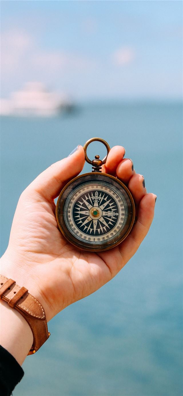 person holding compass iPhone 11 wallpaper 