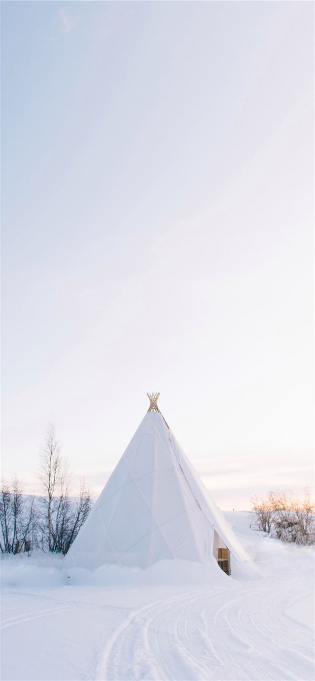 white tipi tent covered with snow iPhone 11 wallpaper 