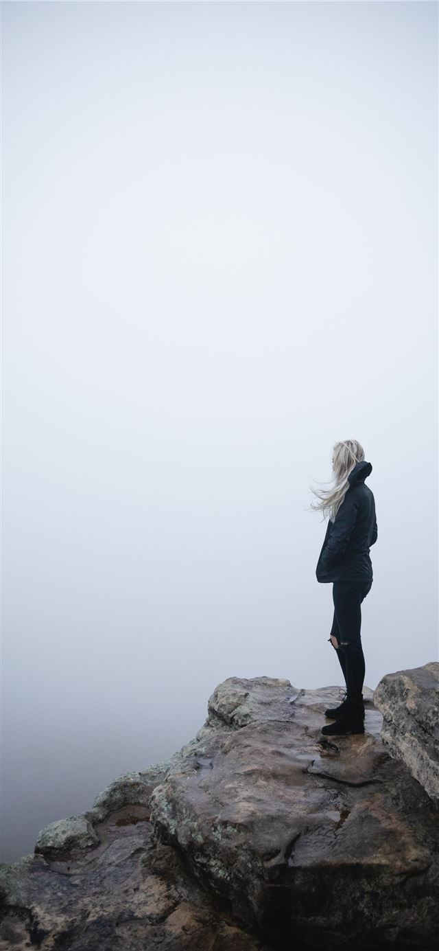 woman standing on cliff iPhone 11 wallpaper 