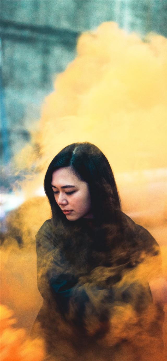 woman surrounded by orange smoke iPhone 11 wallpaper 