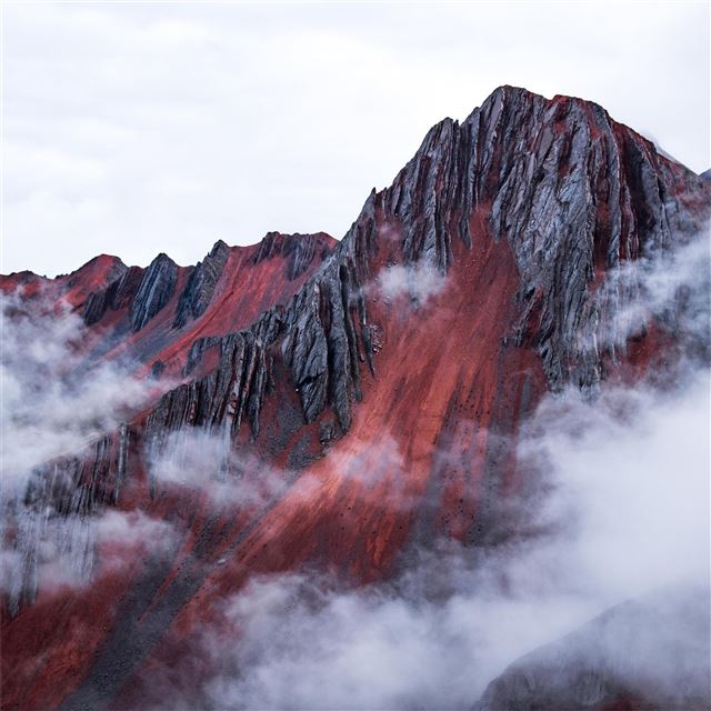 red mountain peeking out behind the clouds cusco p... iPad Air wallpaper 