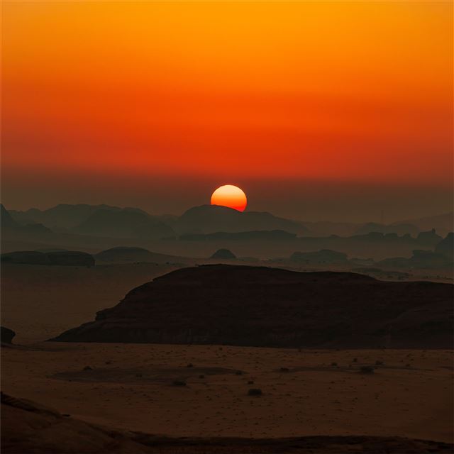 sun is setting over the mountains in plains 8k iPad wallpaper 